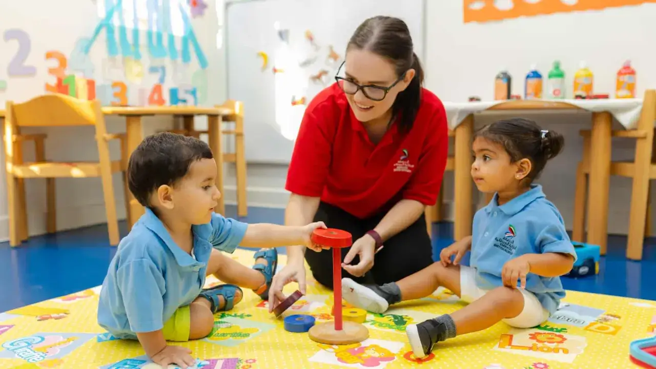 Lehrerin erkl&auml;rt Kindern die Regeln der gewaltfreien Kommunikation beim Spielen.