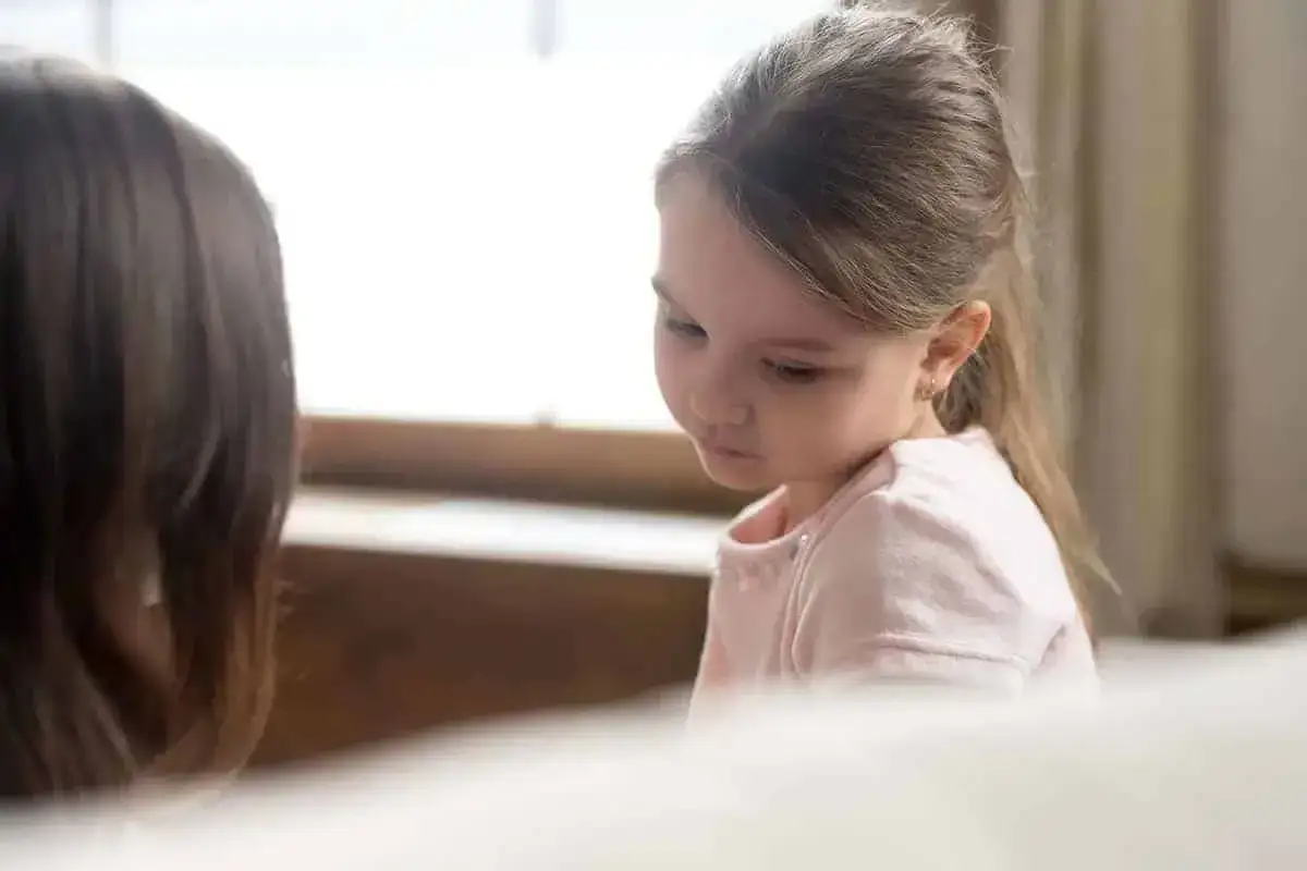 Ein M&auml;dchen h&ouml;rt nachdenklich zu, als ein Erwachsener versucht, den Tod mit Kindern zu besprechen.